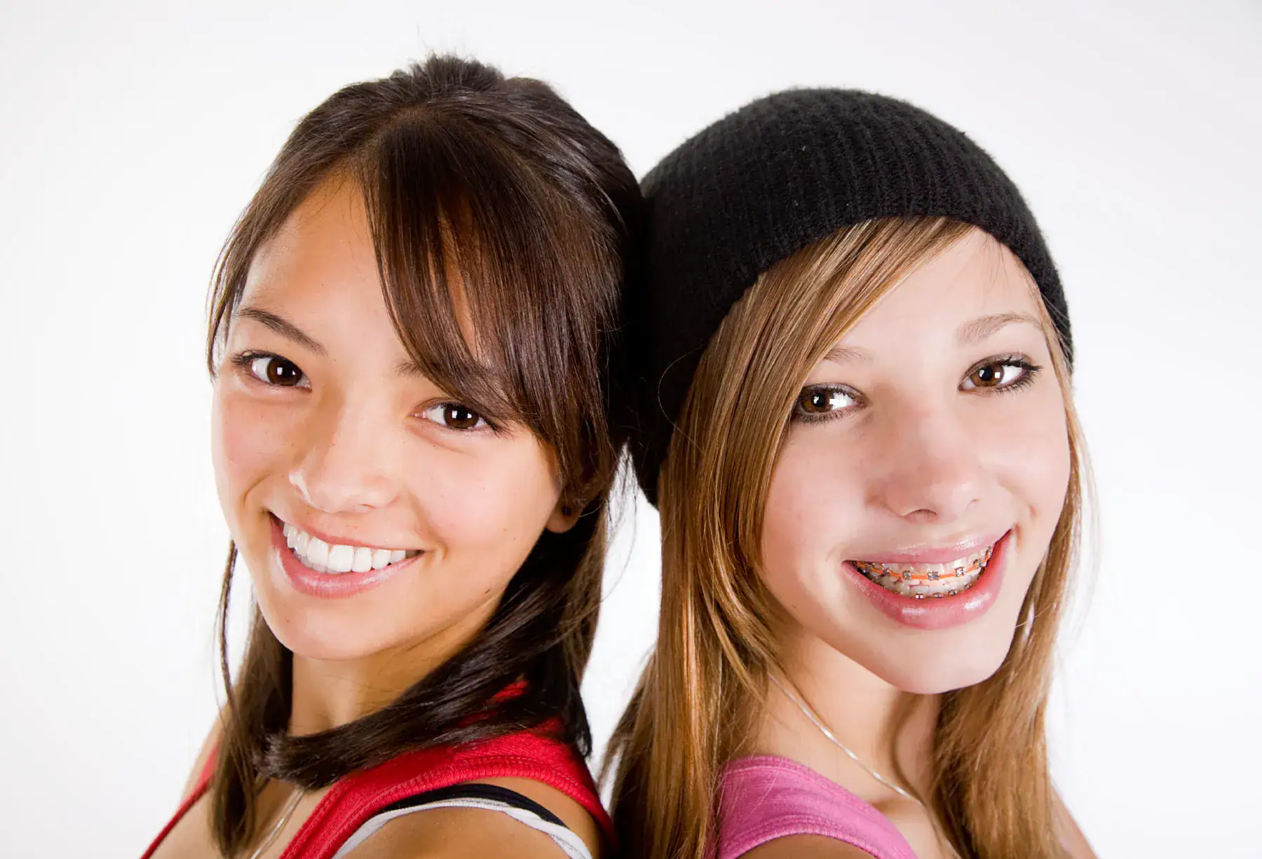 Teen orthodontic patients smiling with braces at Empower Orthodontics with Best Price Guarantee.